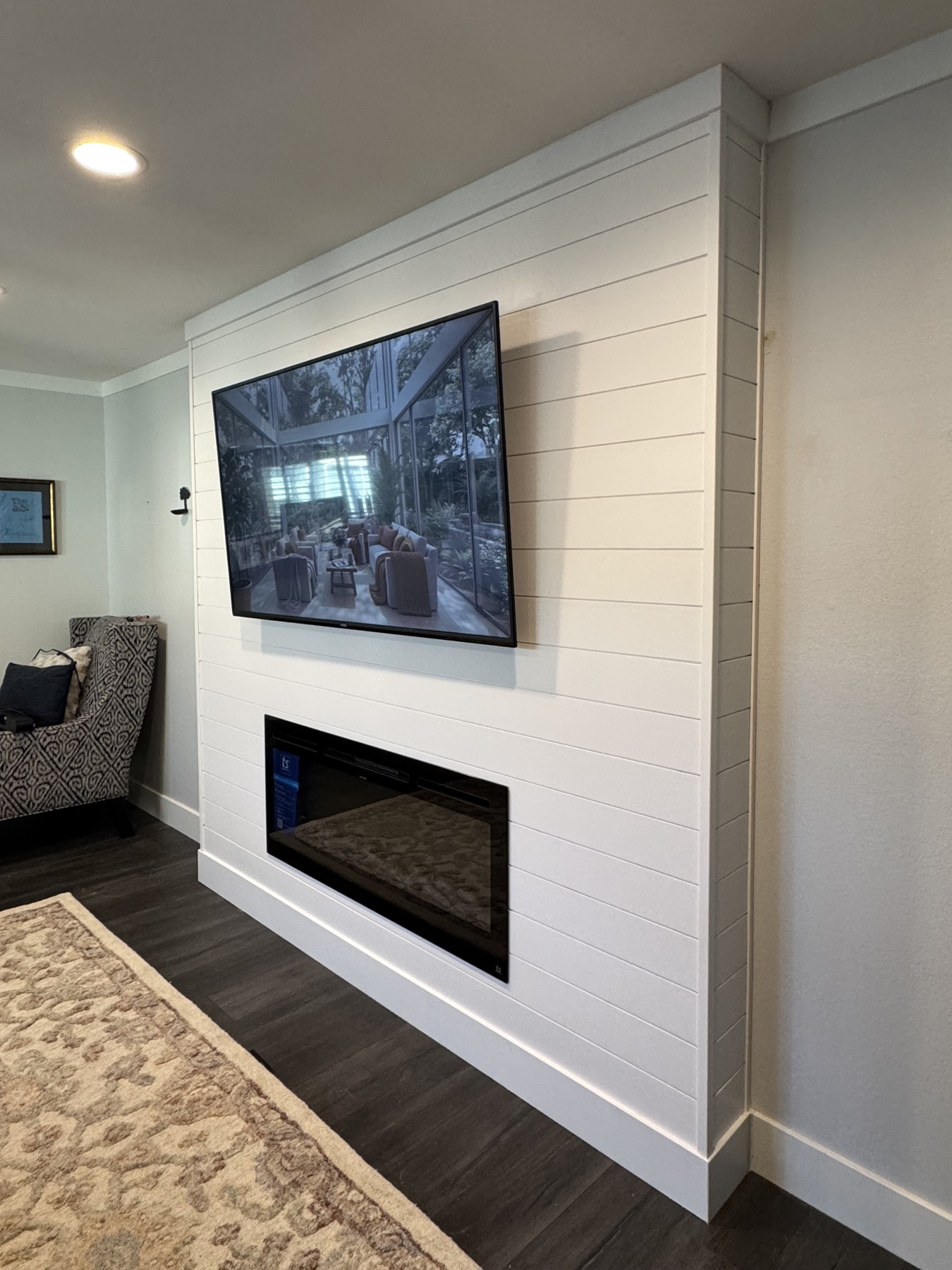 Before the mantel — TV and fireplace installed; the wood detail comes next