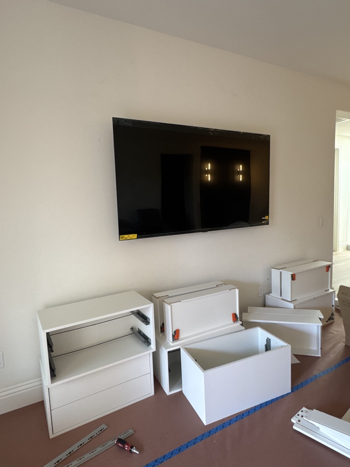 Early build — cabinet assembly at the existing wall